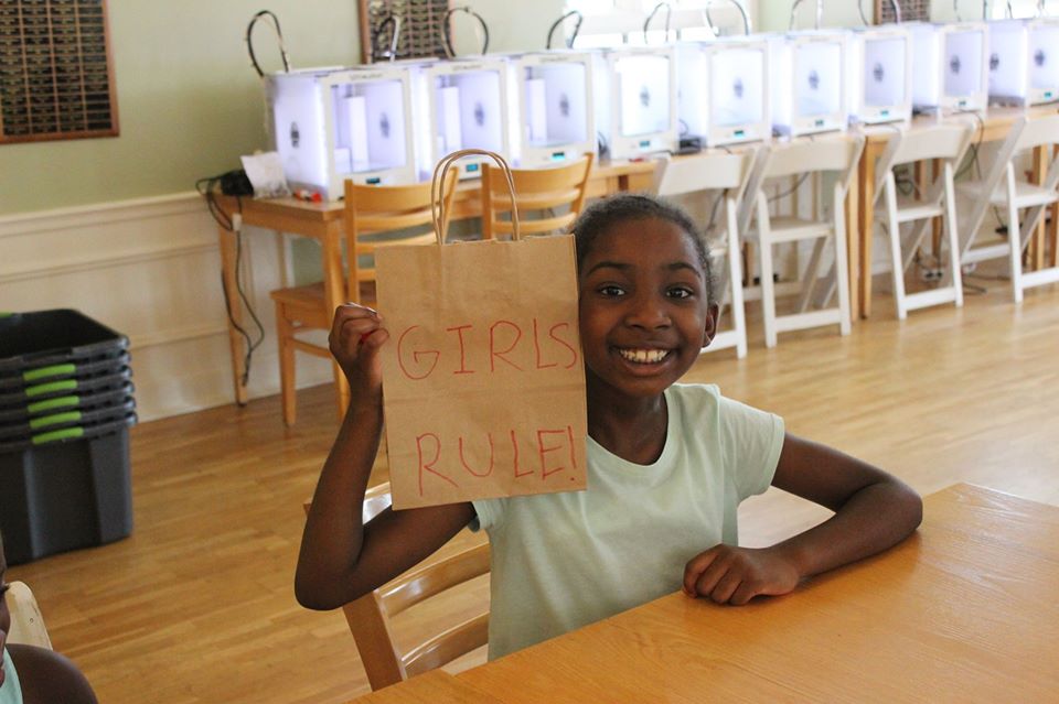 Young girl holding a sign that says Girls Rule