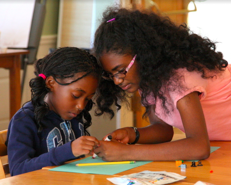 Two young girls working on an art project